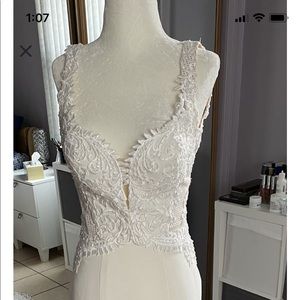 EMBROIDERED CREPE BRIDAL GOWN WITH A STATEMENT TRAIN